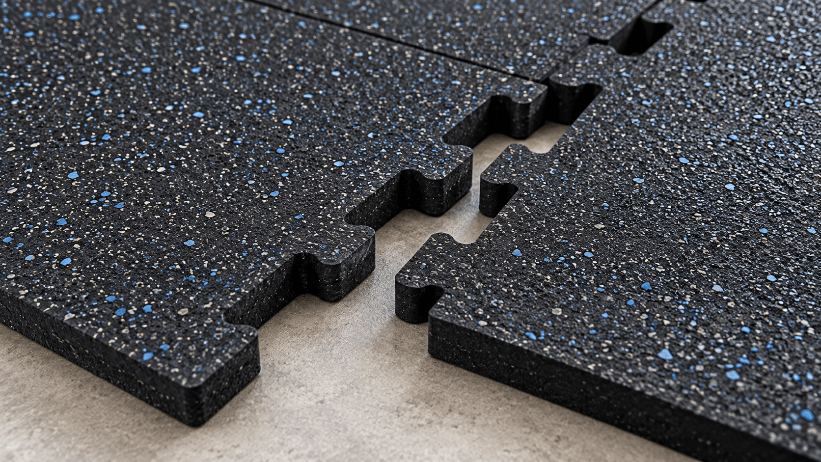 Close-up of interlocking rubber gym tiles showing textured surface and connecting edges