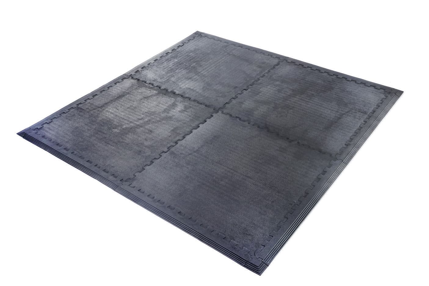 Four connected Shield Lock rubber tiles with interlocking seams and perimeter edges.
